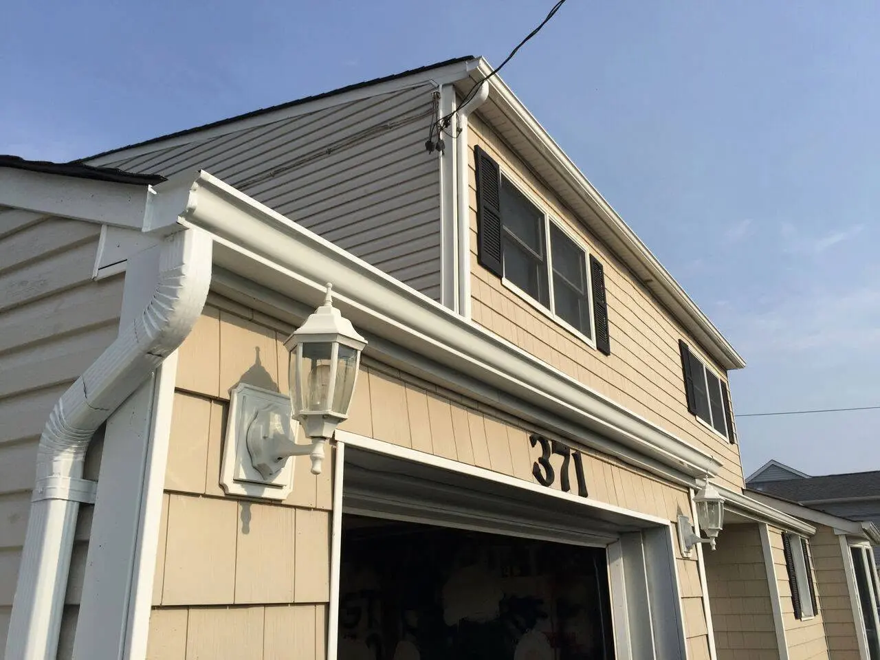 White gutter and downspout installation